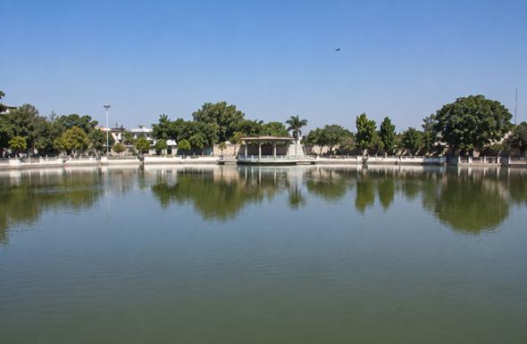 Raja Ka Tal lake in Firozabad, featured on the Resume Writing Services Firozabad page, with calm water, landscaped surroundings, and a clear blue sky.