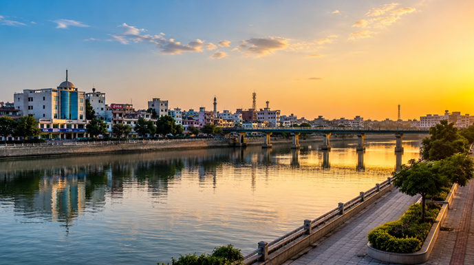 Scenic Mosam River Waterfront in Malegaon with a modern city skyline, calm river, bridge, and lush greenery under a beautiful golden sunset, representing Resume Writing Services Malegaon.