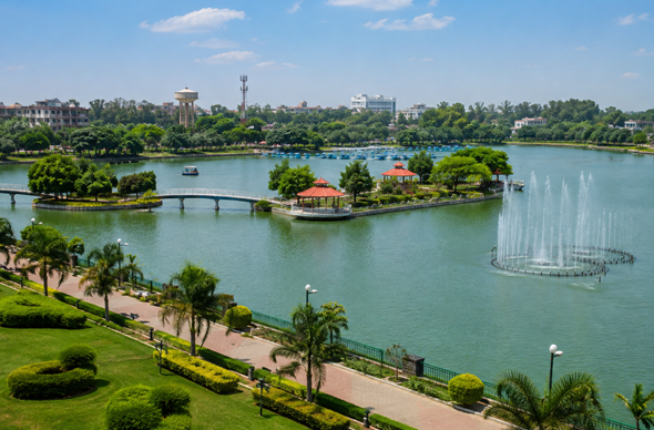 Scenic view of City Park Bokaro with a beautiful lake, greenery, landscaped pathways, islands, and fountains